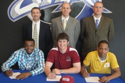 3 Players Signing Contracts with 3 coaches standing behind