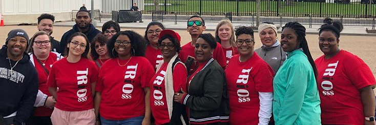 Group of Trio students wearing red Trio students outside