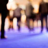 blurred image of a group of people in business clothes