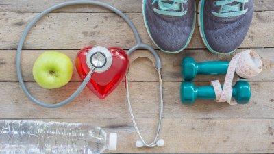 Various health and exercise items laying on wooden table