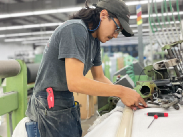 Young Apprentice works in industrial facility