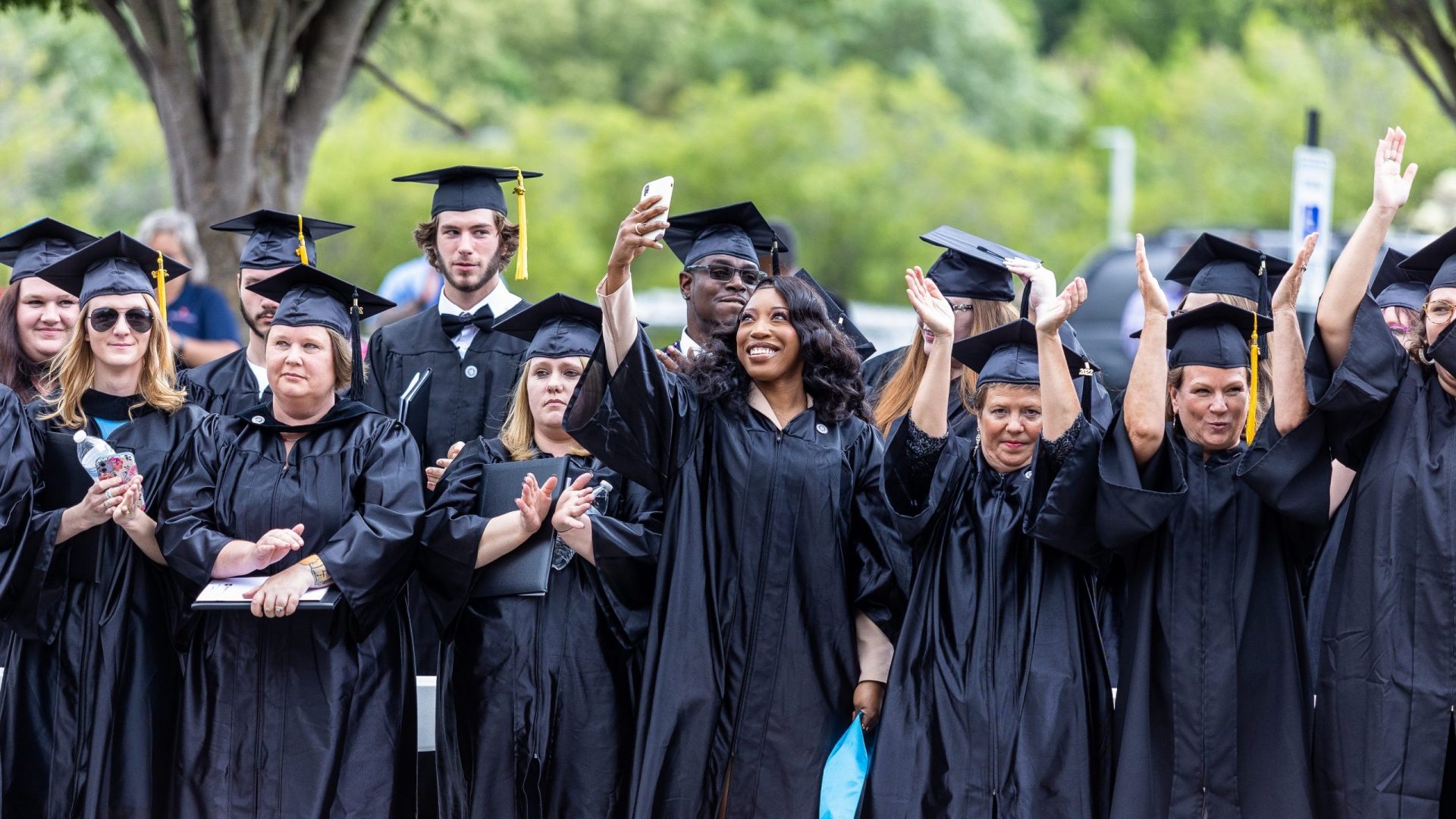 Group of graduates in black cap and gown