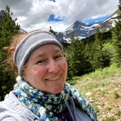 Trudy Brown outdoors in mountainous area.