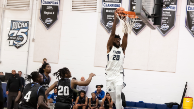 Number 20 Jakob Moore Dunking a Basketball
