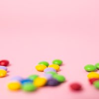 pink background with valentine's candy in the foreground.