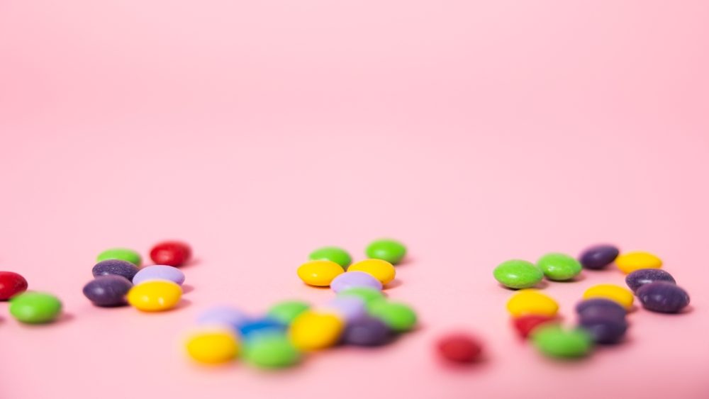 pink background with valentine's candy in the foreground.