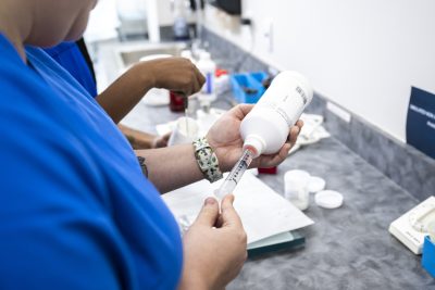 Close up of pharmacy student filling a prescription