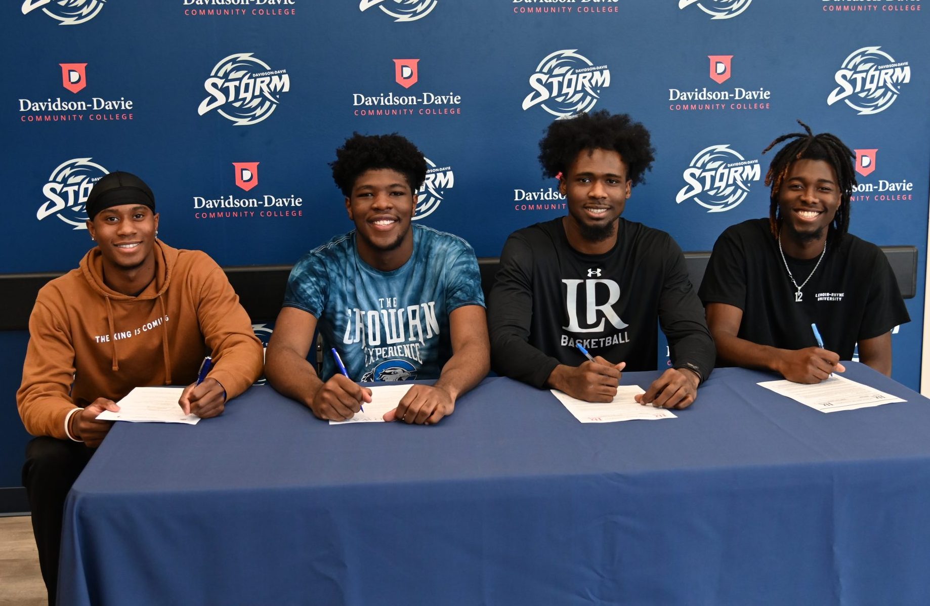 Storm Players Jonathan Foust, Jahiem Taylor, Keith Reese Chase Mebane signing 4-year school agreements in front of STORM Athletics backdrop