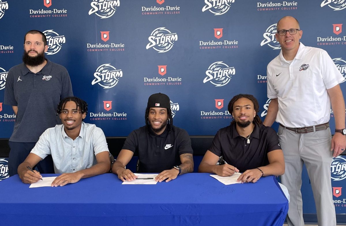 Storm Players Nygie Stroman, Trey Fields, and Mike Wade signing 4-year school agreements in front of STORM Athletics backdrop