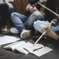 Group of teenagers holding instruments in casual music session