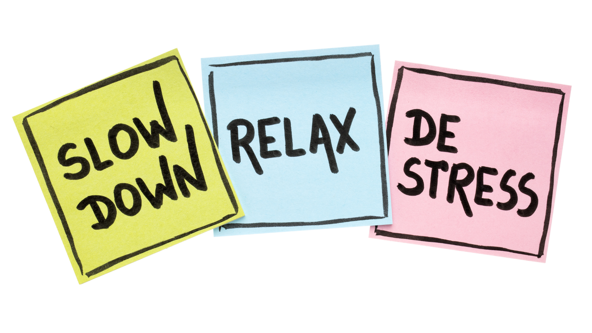 Three sticky notes displaying the words "Slow Down", "Relax", "De Stress".