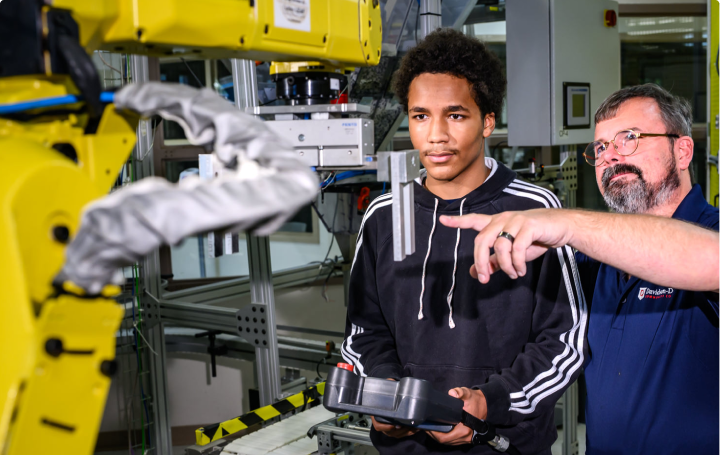 an engineering student and instructor working with equipment