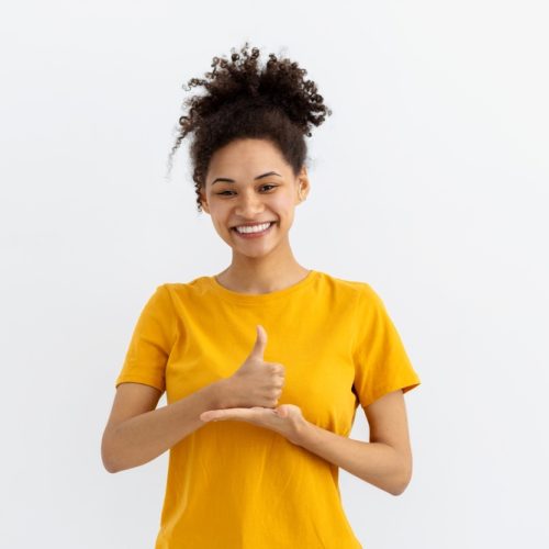 Deaf,Mute,Young,African,American,Woman,On,White,Background young girl in yellow shirt doing sign language