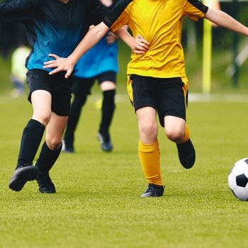 Five,Soccer,Players,Run,Toward,Soccer,Goal,And,Kick,The Soccer